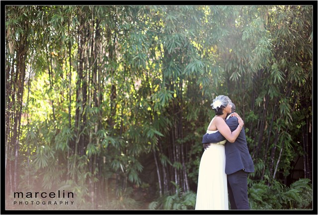 bride groom embrace at the tropical garden setting of the palms hotel