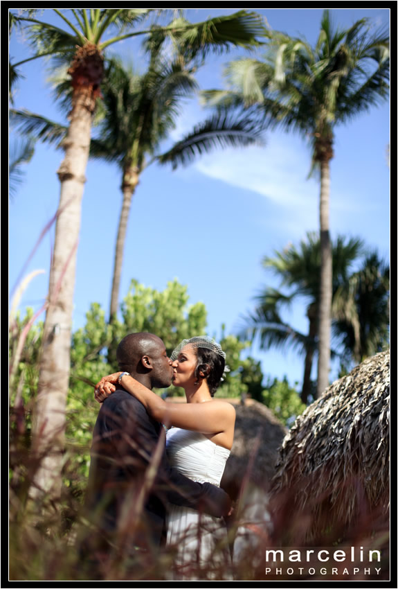 bride and groom kissing tiki hut palms hotel